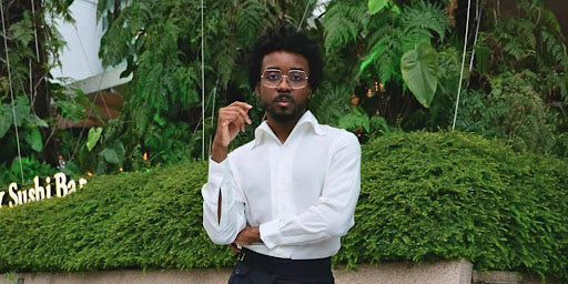 Expat man standing confidently in a tailored white shirt at Capitol Singapore, representing CYC Tailor’s custom menswear for expats.