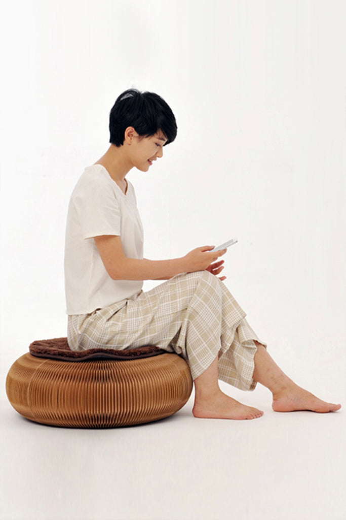 person-sitting-on-brown-paper-futon-pouffe-home-cyc-singapore-size-01